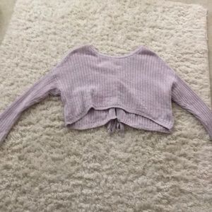 A purple cropped sweater